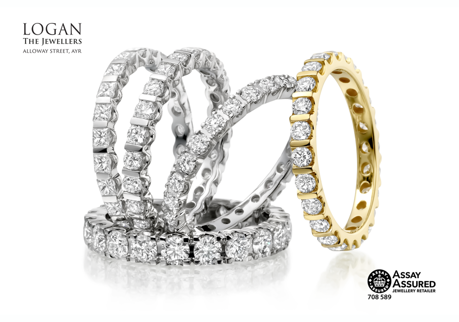 Four white gold and one yellow gold diamond wedding rings